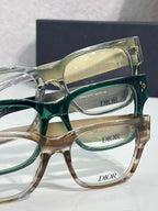 Dior eyeglasses close-up with layered frames in green, clear, and tan tones