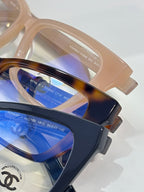 Chanel eyeglasses close-up with blue-tinted lenses and tortoise-brown frame