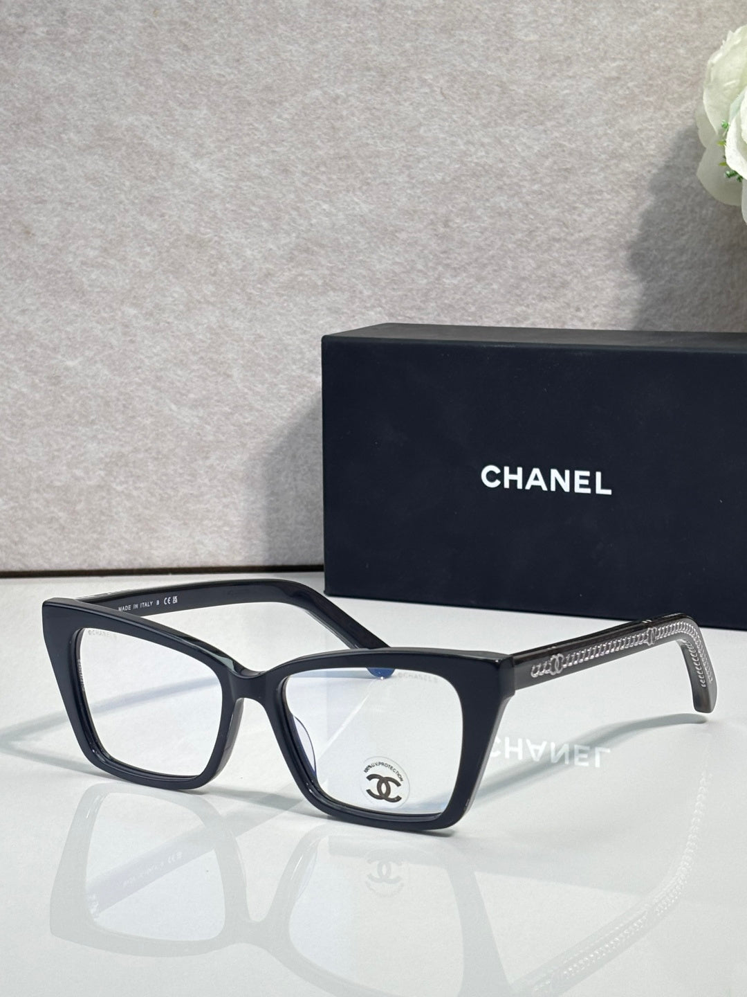 Chanel eyeglasses with black rectangular frame and clear lenses, visible temple logo