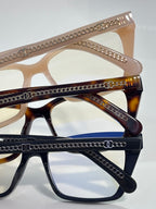 Chanel eyeglasses close-up with gold chain trim and tortoise-brown acetate temples