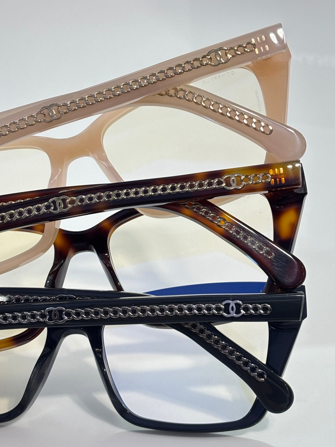 Chanel eyeglasses close-up with gold chain trim and tortoise-brown acetate temples