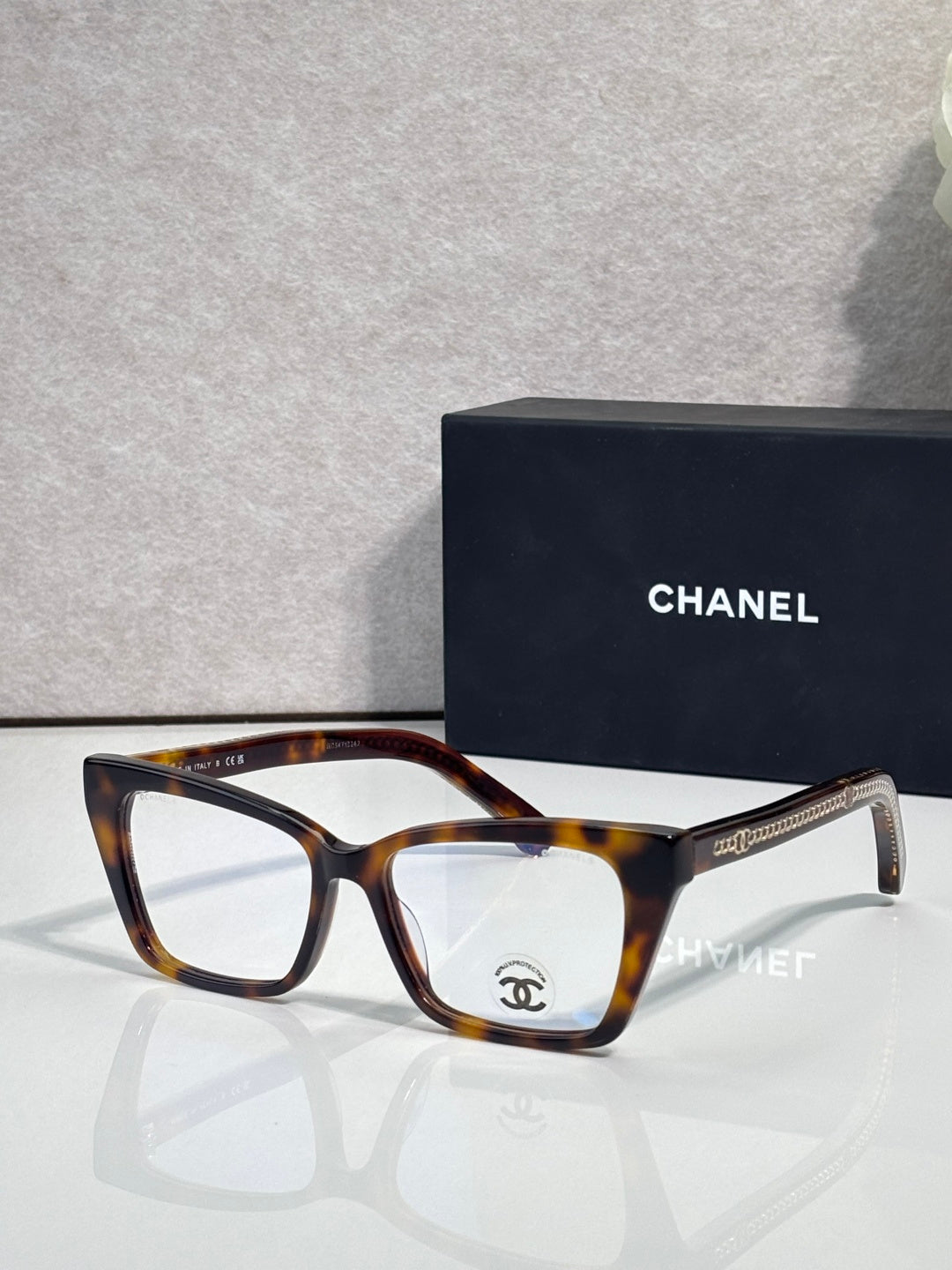Chanel eyeglasses with tortoise brown rectangular frame and clear lenses, gold logo detail