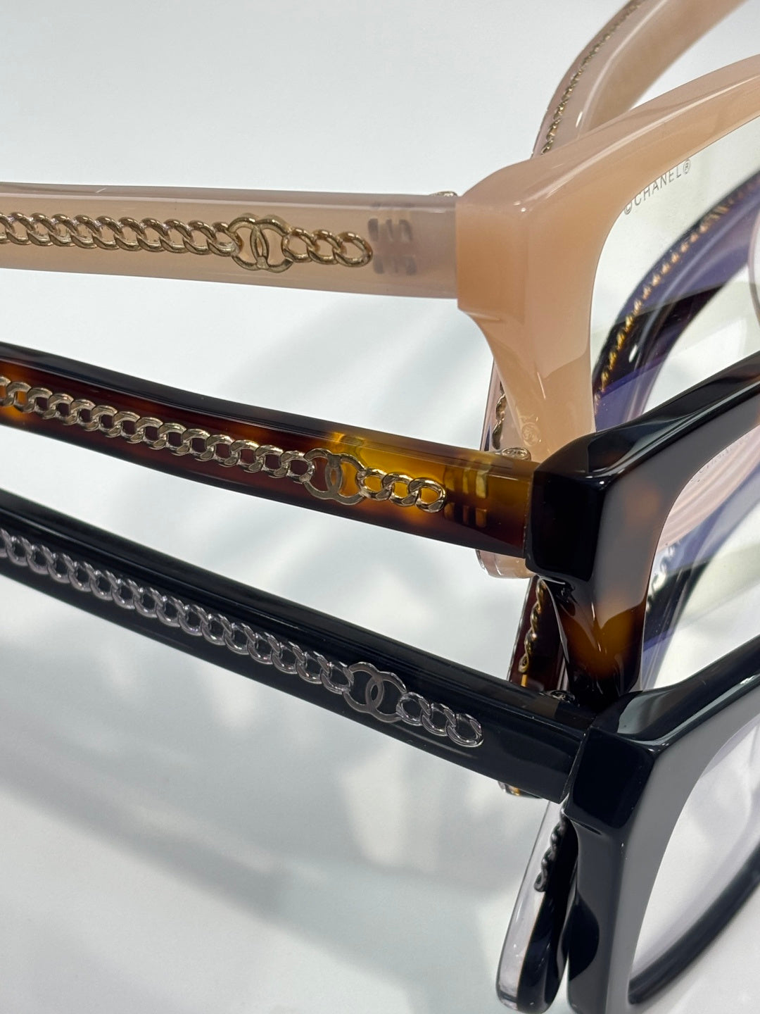 Chanel eyeglasses temple close-up with gold chain detailing and dark acetate arms