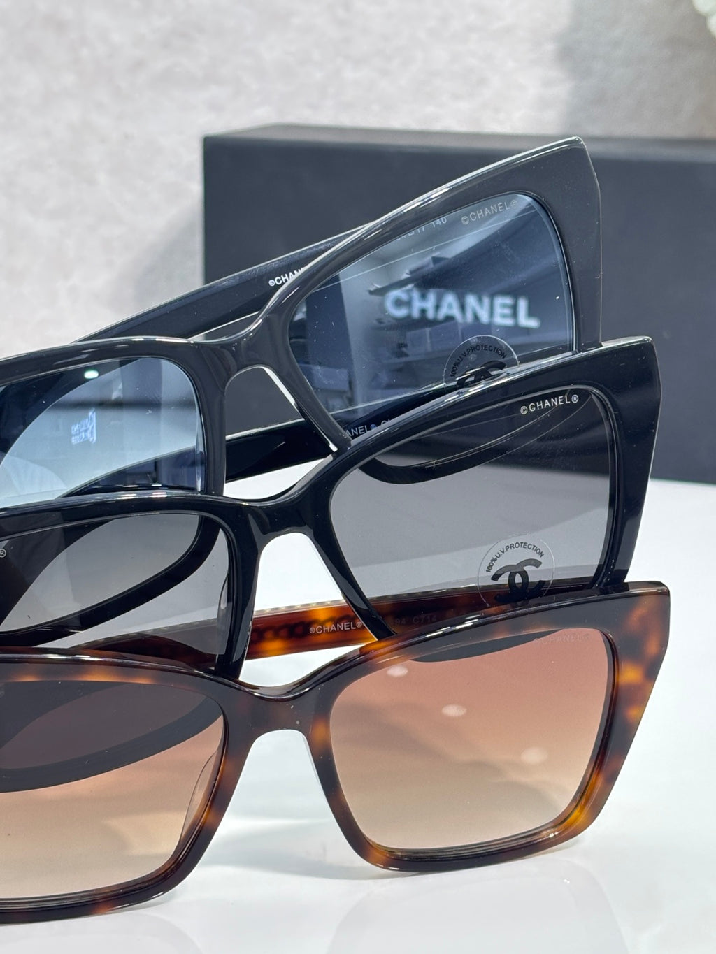 Chanel sunglasses stack view with black and tortoiseshell frames, tinted lenses