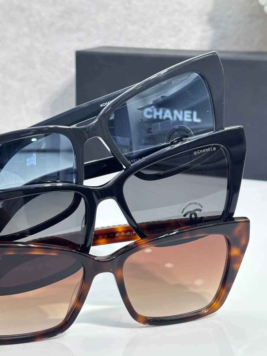 Chanel sunglasses stack view with black and tortoiseshell frames, tinted lenses
