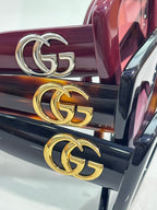 Gucci sunglasses temple detail with gold GG emblem on glossy arms