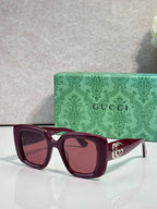 Gucci square sunglasses with burgundy frames, tinted lenses, and gold GG temple detail