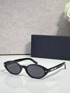 Black Dior glasses with star accents and dark blue round lenses