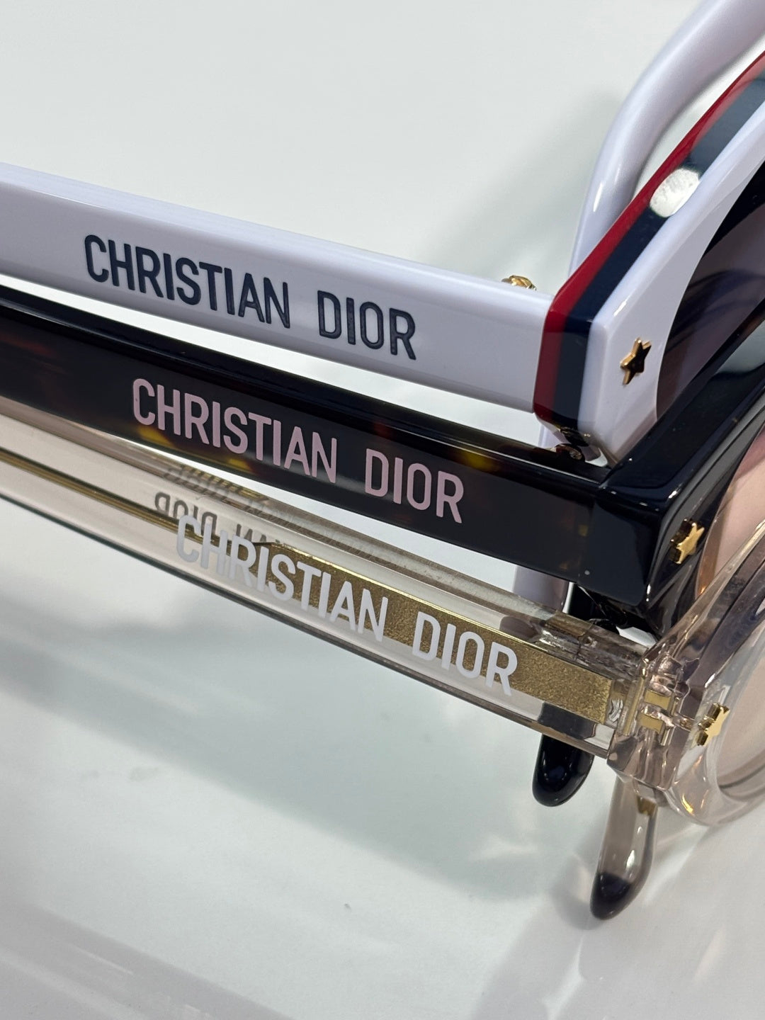 Dior glasses displayed on a branded case with bold CHRISTIAN DIOR text