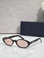 Brown Dior glasses with star accents and pink-tinted round lenses