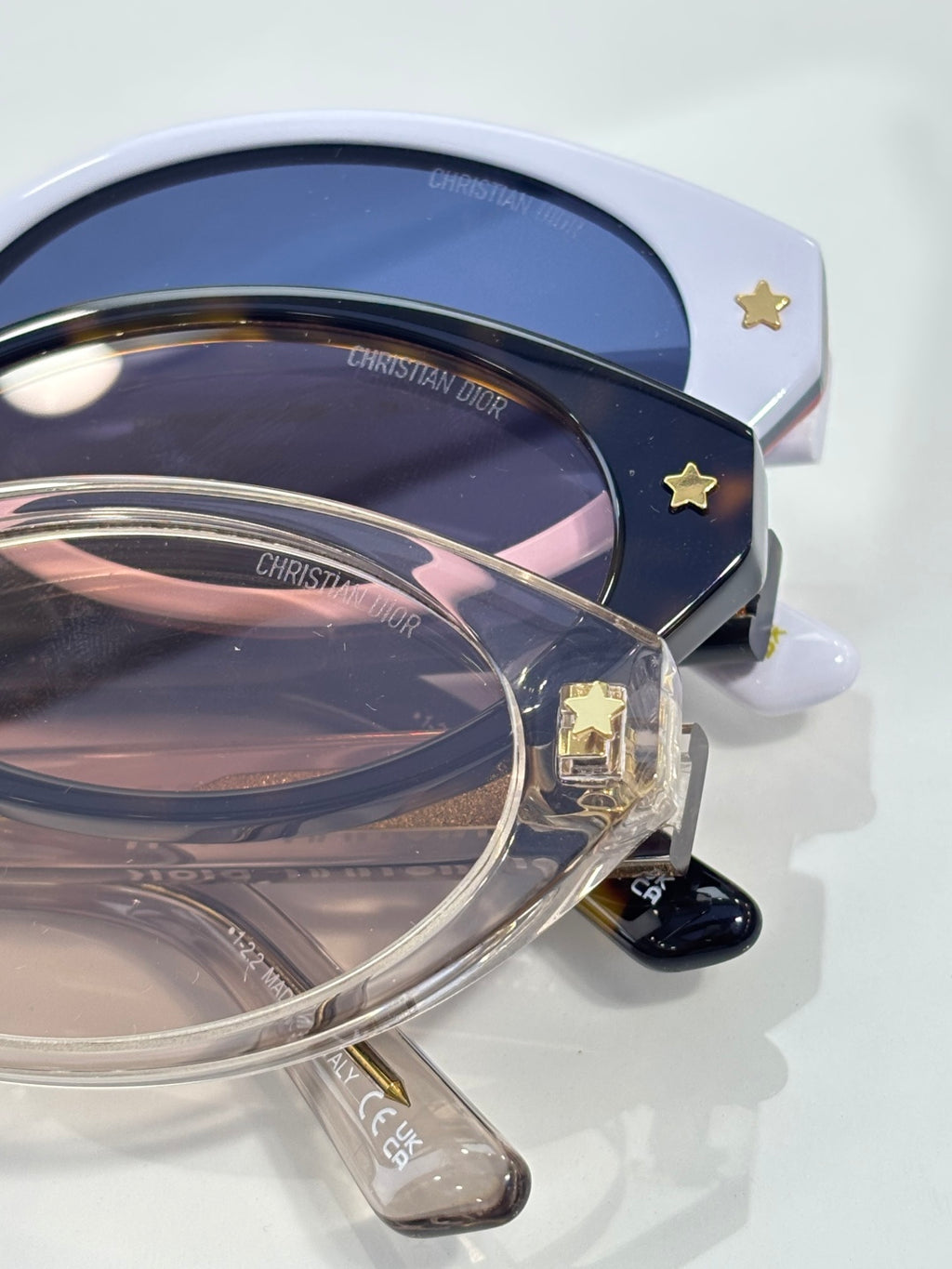 White Dior glasses with navy lenses and star detail on side