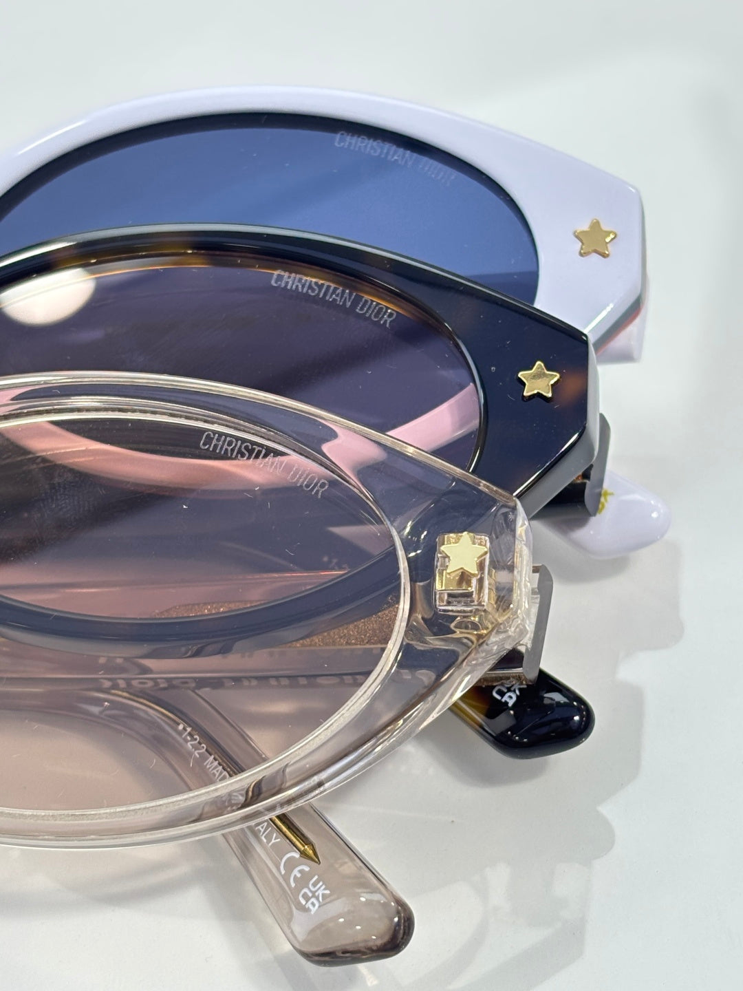 White Dior glasses with navy lenses and star detail on side