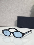 Black Dior glasses with star accents and light blue round lenses