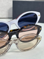 White Dior glasses with navy lenses and star detail on temple