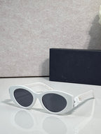 White round sunglasses with dark-tinted lenses and white floral temple accents