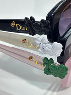 Dior sunglasses with white and green floral temple embellishments and logo detail