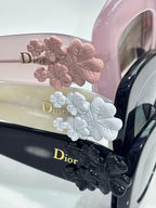 Dior glasses temple detail with floral embellishments and Dior logo on the arm.