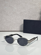 Gold cat-eye sunglasses with dark blue tinted lenses and Dior logo on temple