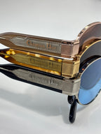 Gold and rose-gold temple with engraved text on Dior sunglasses frame