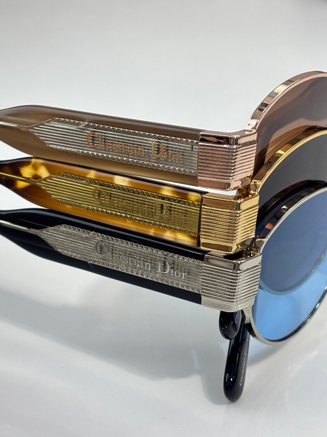 Gold and rose-gold temple with engraved text on Dior sunglasses frame