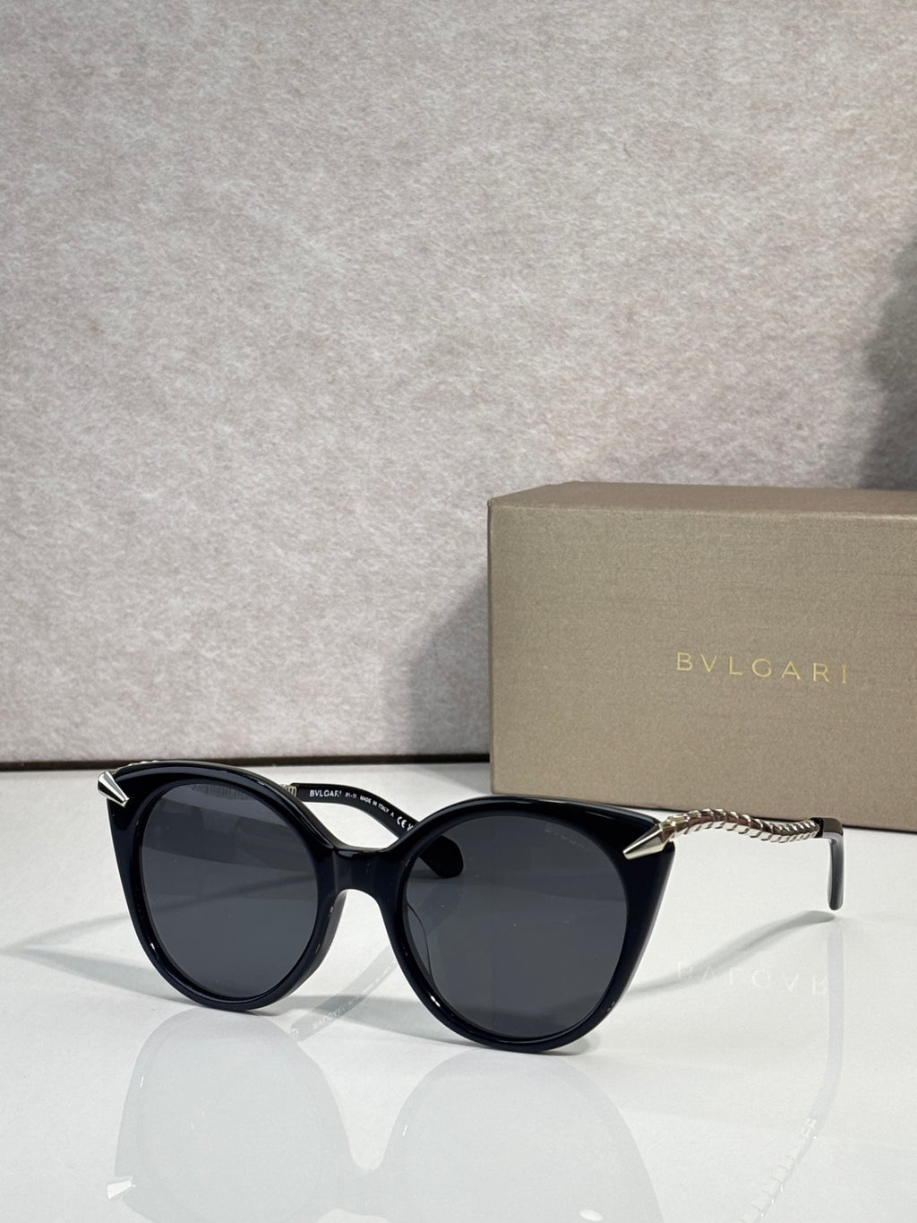 Bvlgari sunglasses, black rounded frames with gold-tone temple tips and dark lenses