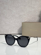 Bvlgari sunglasses, black rounded frames with gold-tone temple tips and dark lenses