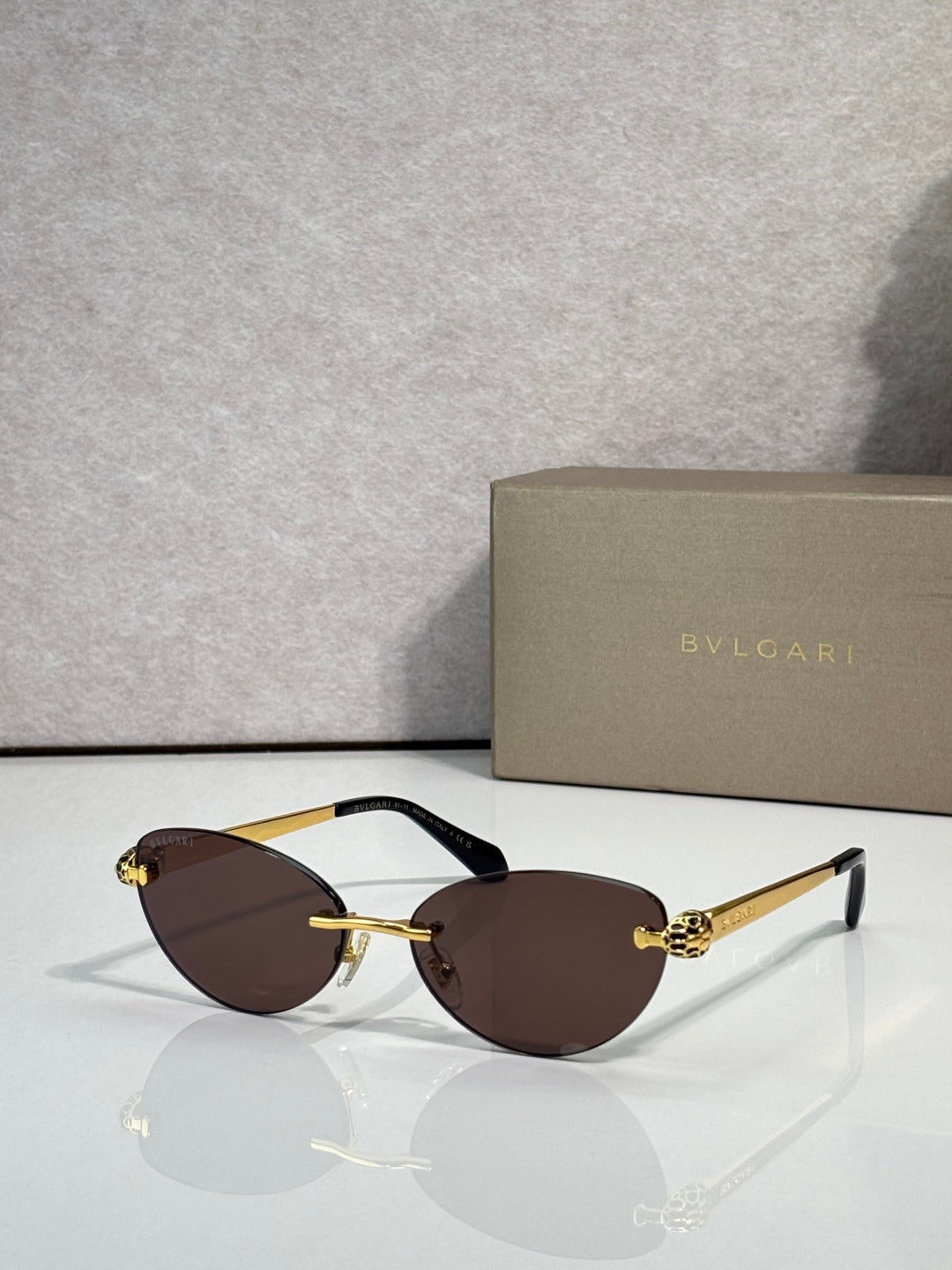 Bvlgari eyeglasses with dark brown lenses, gold frame and black temple tips
