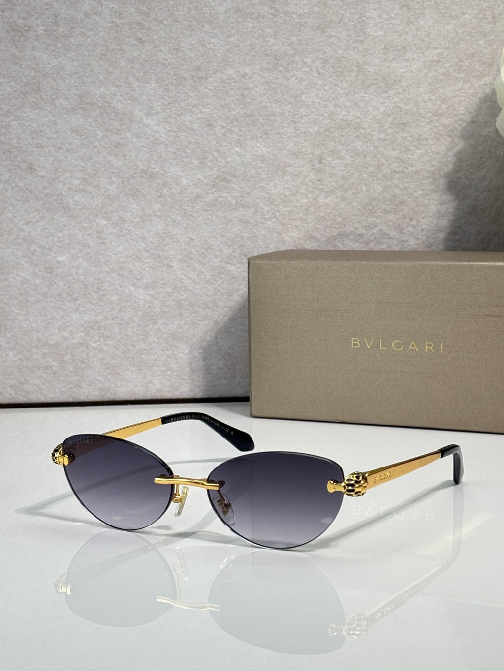 Bvlgari eyeglasses with dark blue lenses, gold frame and black temple tips