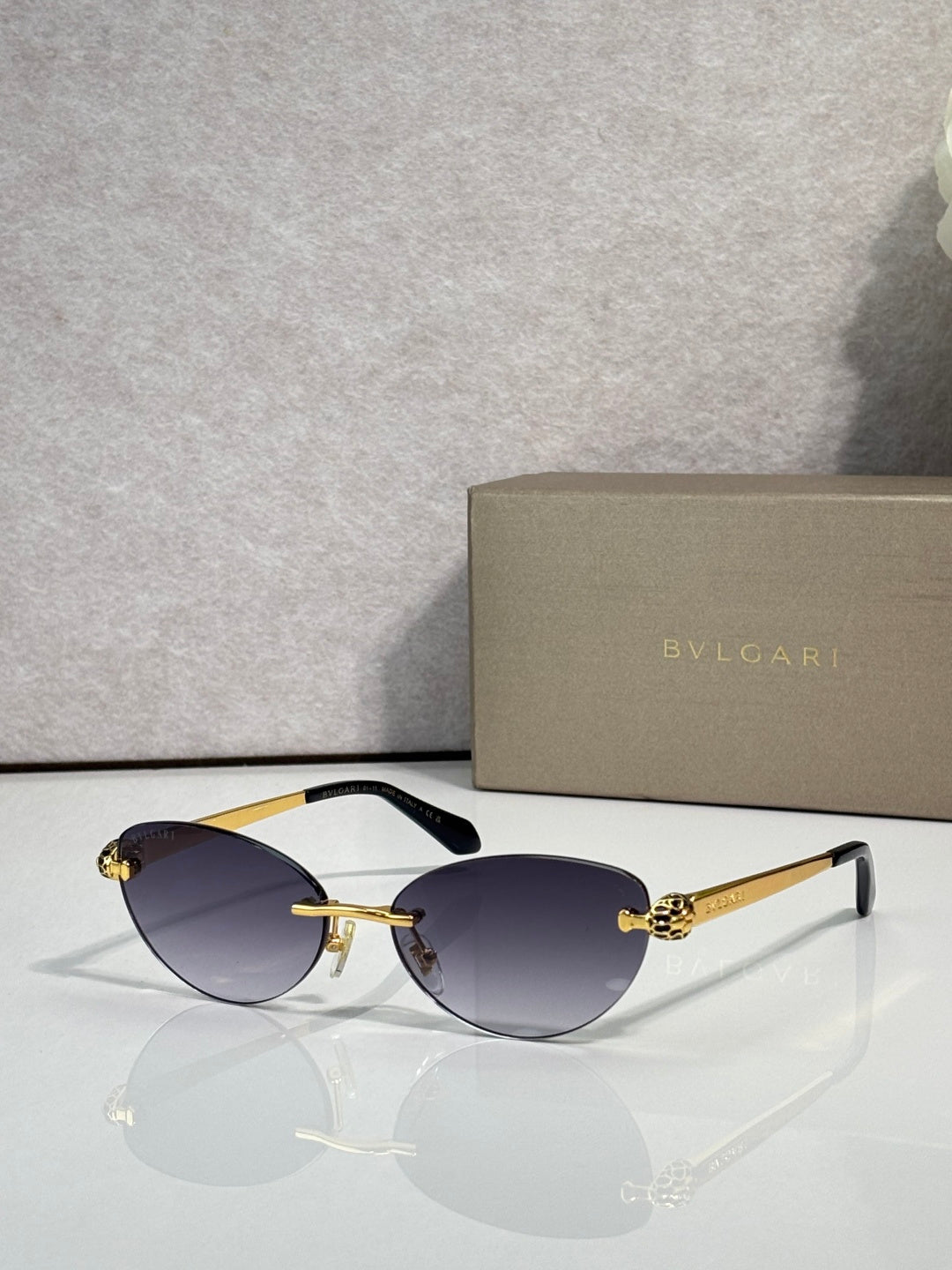 Bvlgari eyeglasses with dark blue lenses, gold frame and black temple tips