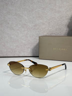 Bvlgari eyeglasses with brown-tinted lenses, gold frame and black temple tips