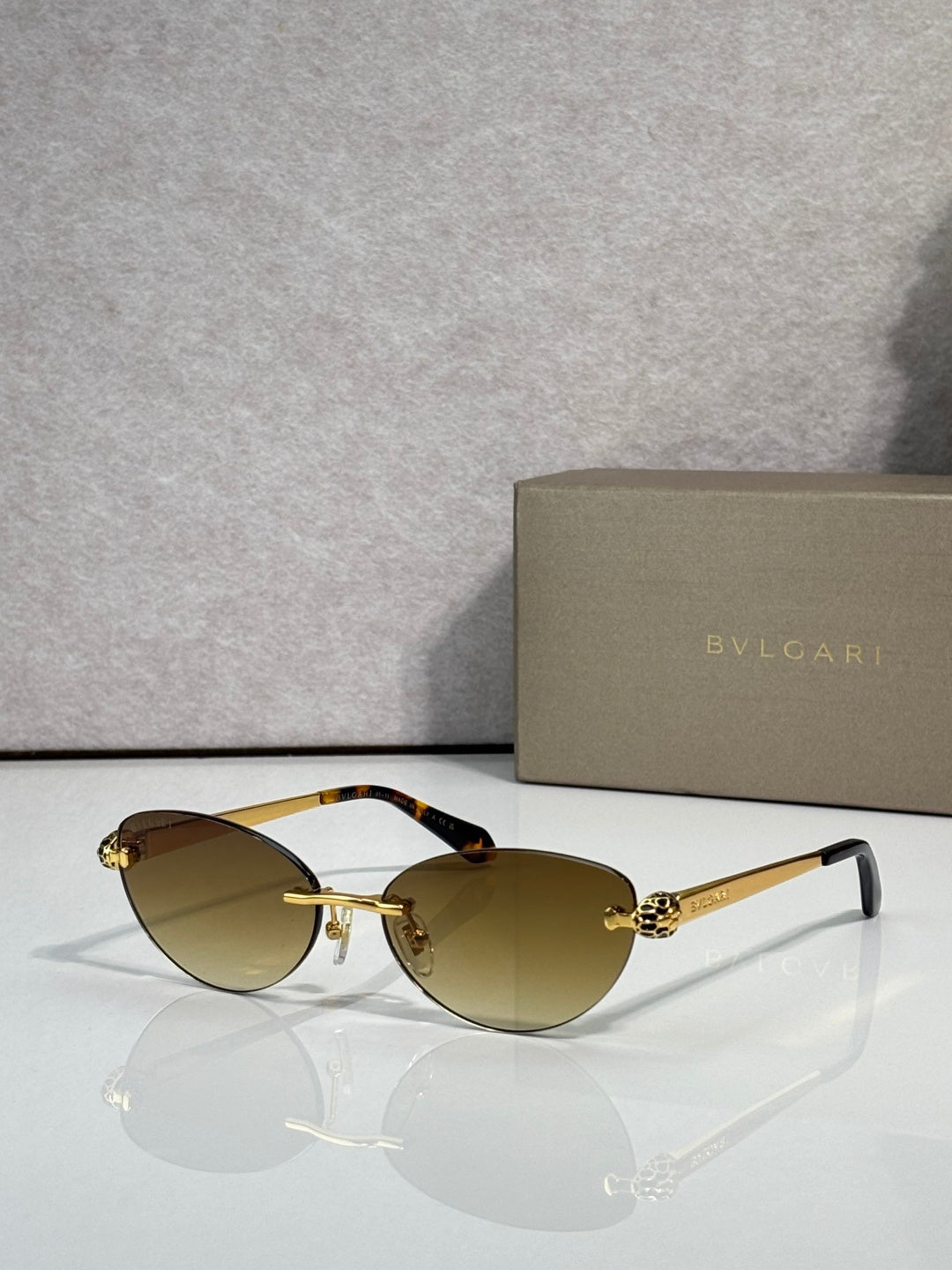 Bvlgari eyeglasses with brown-tinted lenses, gold frame and black temple tips