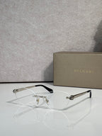 Bvlgari eyeglasses with clear lenses and gold frame, black temple tips