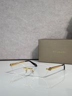 Bvlgari eyeglasses with tinted amber lenses, gold frame and black temple tips