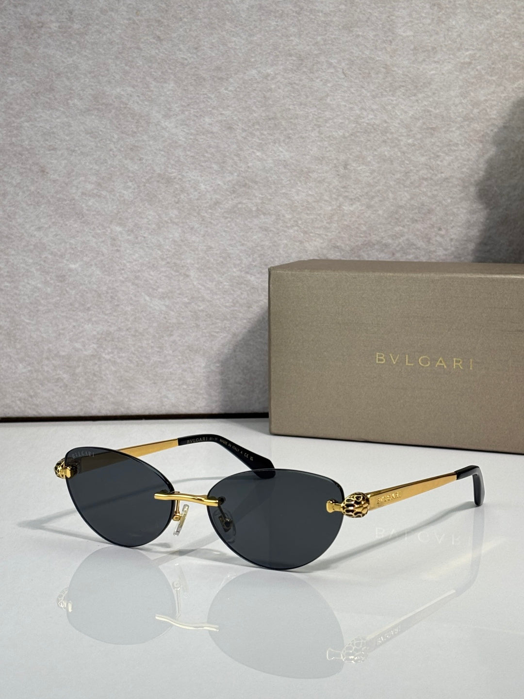 Bvlgari eyeglasses with dark gray lenses, gold frame and black temple tips