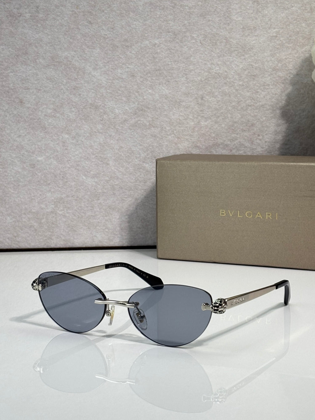 Bvlgari eyeglasses with blue-gray lenses, gold frame and black temple tips