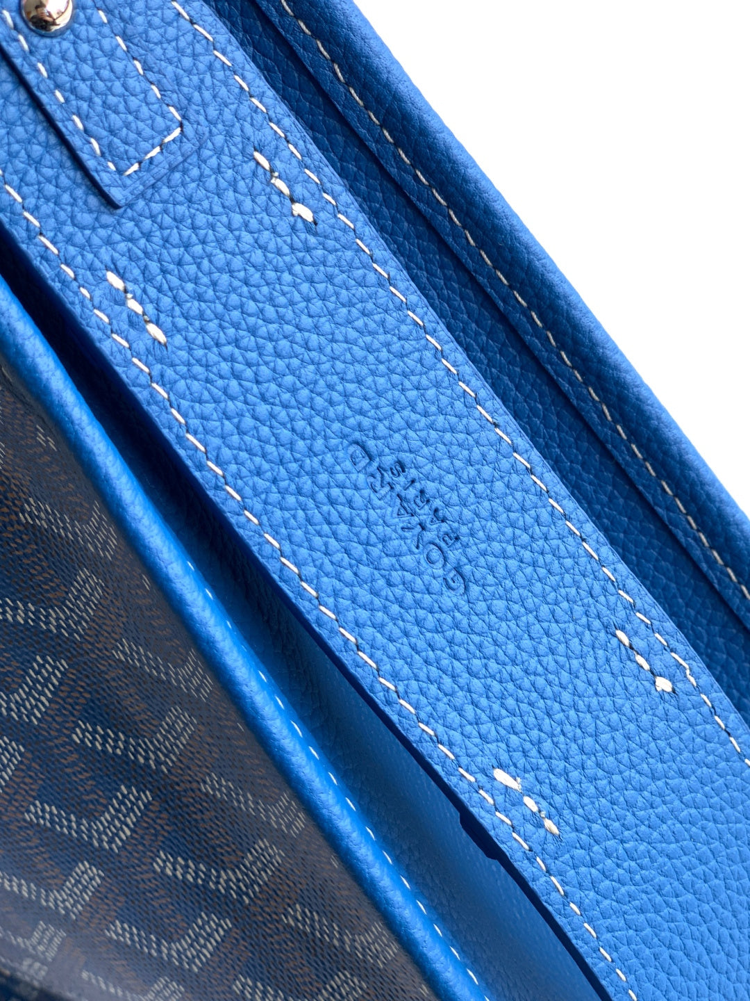 Goyard blue bag detail with pebble-grain leather panel and contrast stitching lines