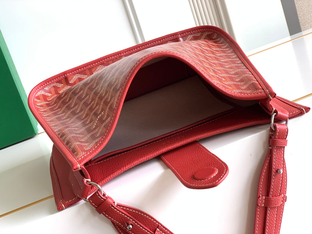 Red handbag interior view with open top and leather shoulder strap