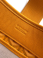 Close-up of mustard leather pocket trim and stitched edge on the bag