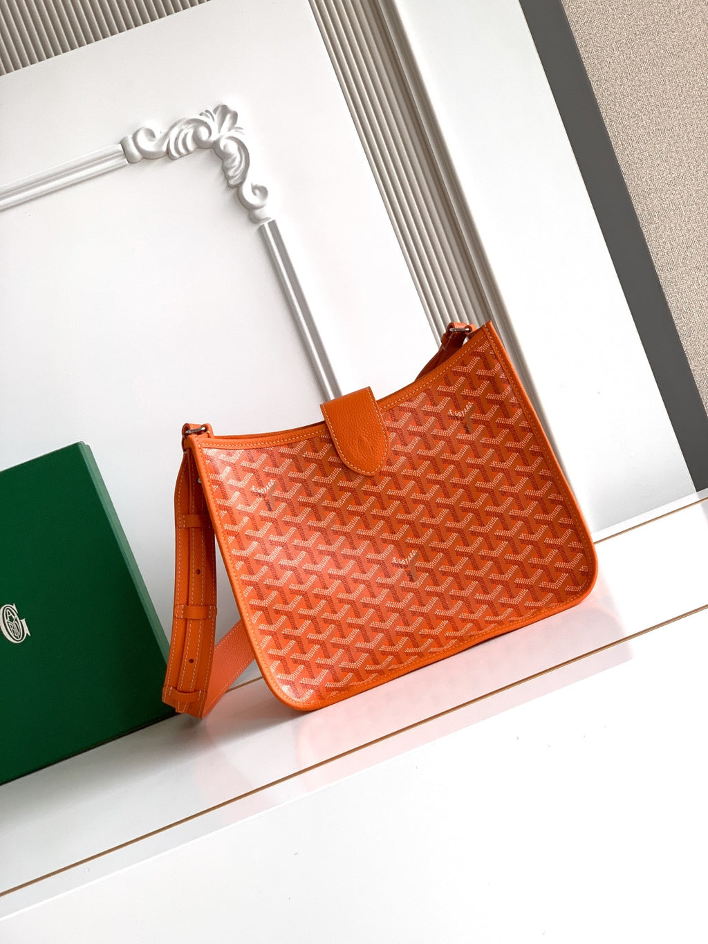 Orange monogram canvas bag with leather top handle and adjustable shoulder strap