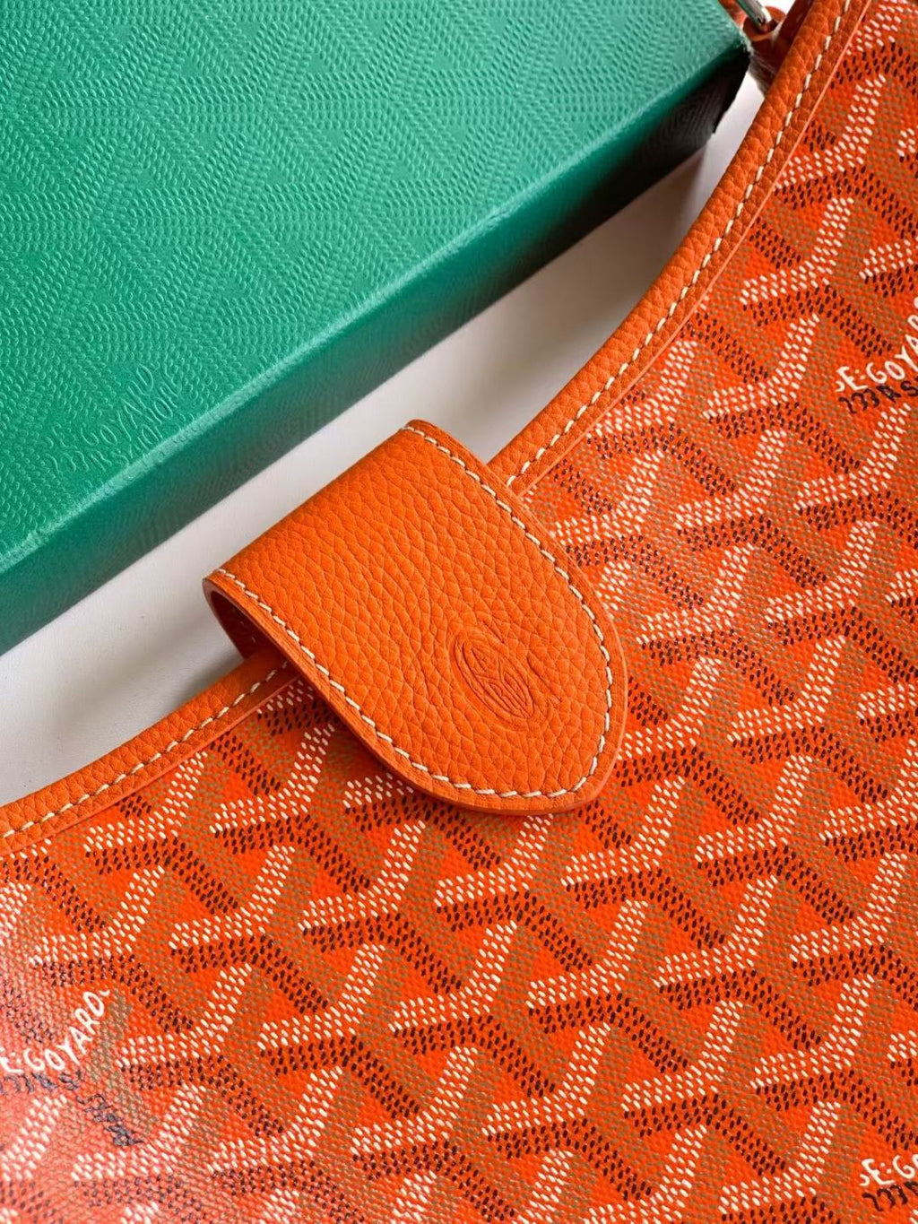 Orange monogram canvas bag with leather flap pocket and contrast stitching