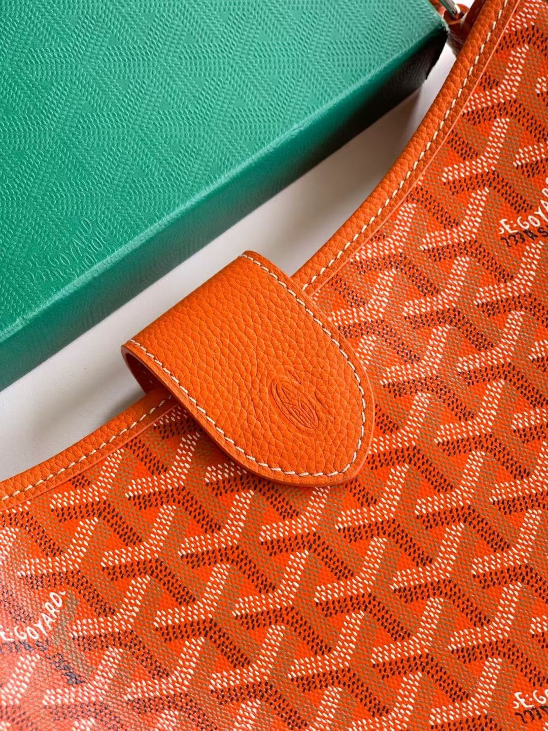 Orange monogram canvas bag with leather flap pocket and contrast stitching
