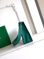 Teal leather Goyard bag with top handle and adjustable shoulder strap