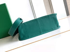 Teal leather clutch bag with top handle and short shoulder strap