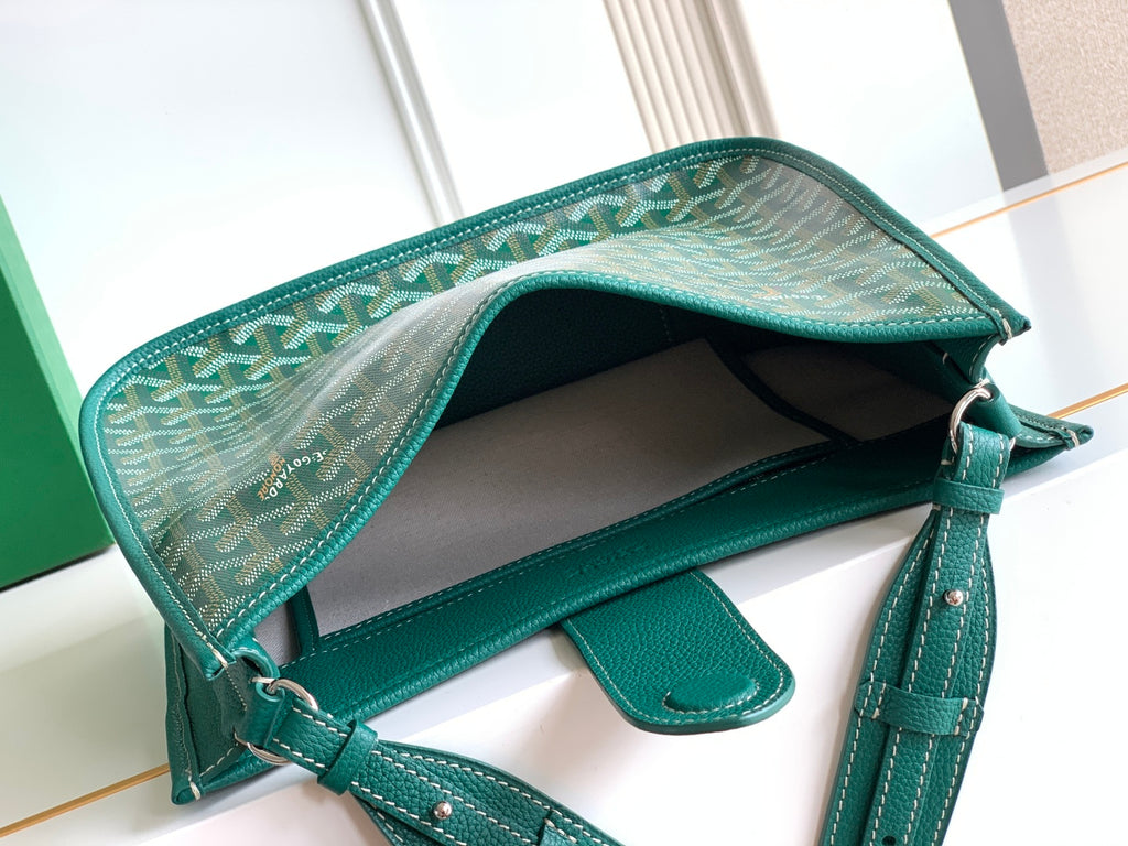 Teal Goyard bag open with interior lining and leather shoulder strap