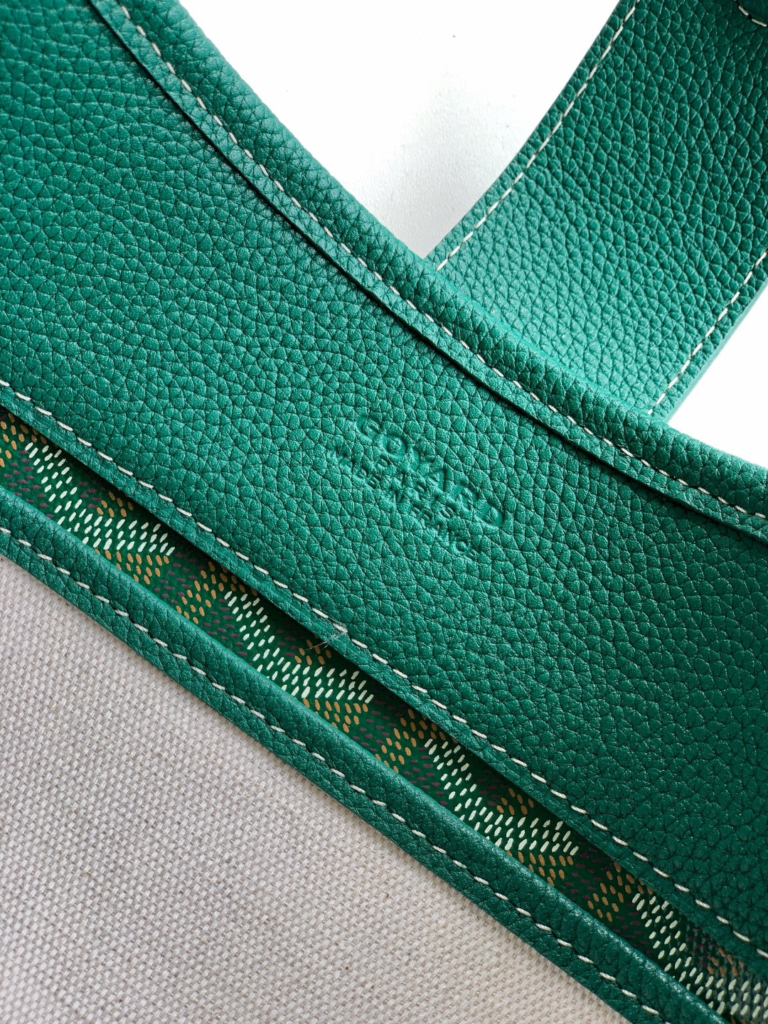 Teal leather strap and stitched edging on patterned canvas Goyard bag