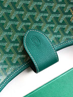Teal leather trim on patterned canvas Goyard bag corner with stitched edge