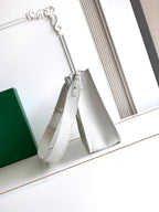 White Goyard tote bag with dual shoulder straps and textured embossed pattern