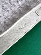 White Goyard tote bag strap seam and textured leather side panel close-up