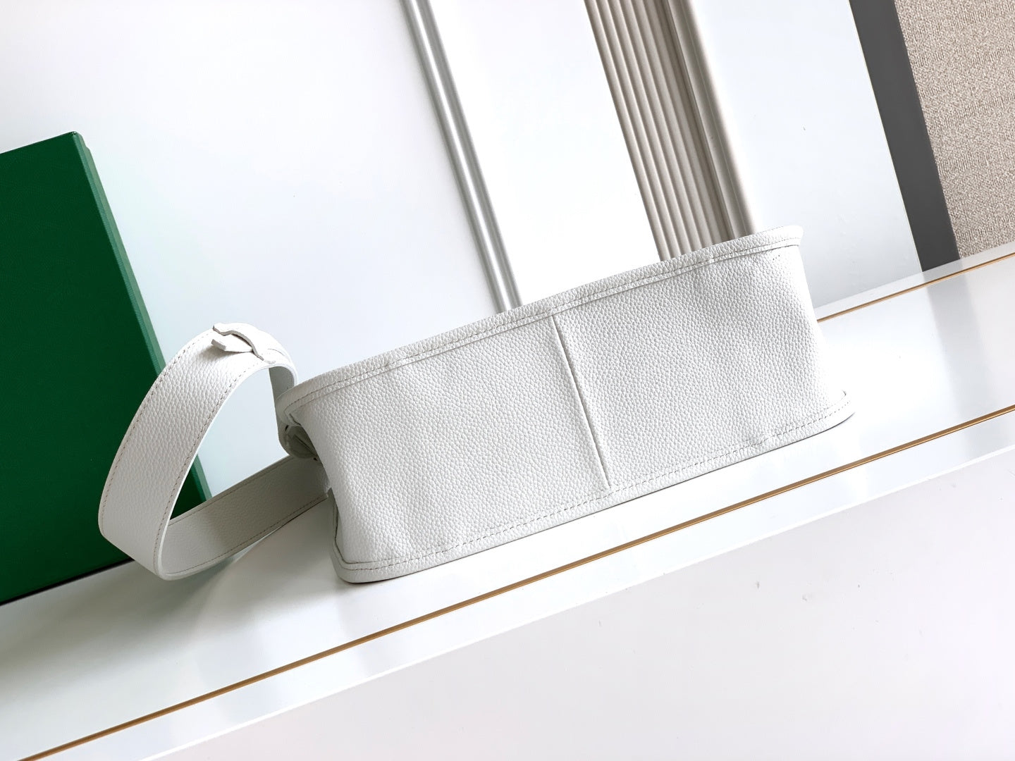 White Goyard tote bag with long strap and structured top flap, embossed texture