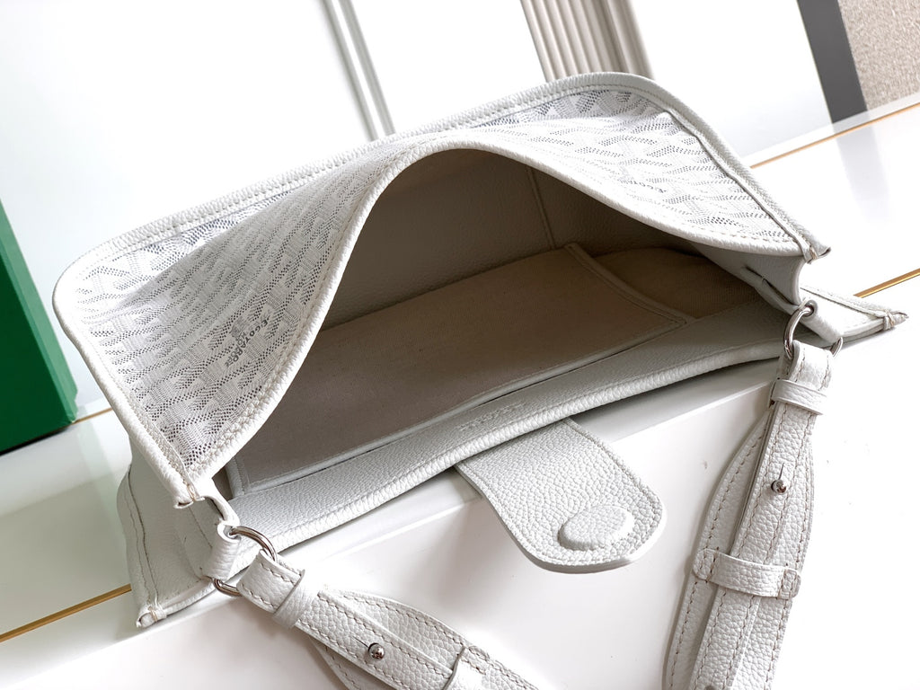 Open top of a white Goyard tote bag showing interior and side pocket